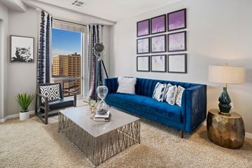 Denver apartment for rent - A living room with a blue couch and a coffee table.