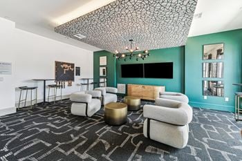 Two-level social clubhouse with game lounge, tv room, kitchen, work-well space with reservable private offices, and conference room