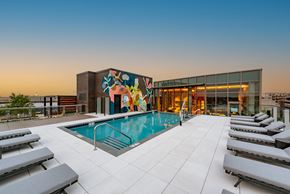 Washington apartment for rent - a pool on the rooftop of a building with a mural on the side
