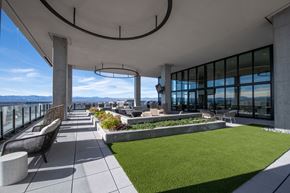 Denver apartment for rent - A patio with a grassy area and a view of the mountains.