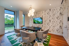 Washington apartment for rent - conference room with a table and chairs and a tv on the wall
