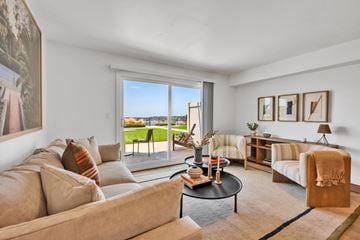 Newport Beach apartment for rent - A living room with a couch, a chair, a coffee table, and a view of the outside.