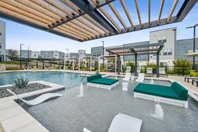 Austin apartment for rent - a resort style pool with lounge chairs and a pergola