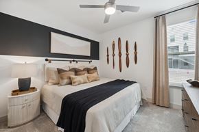 Bastrop apartment for rent - a bedroom with a bed and a ceiling fan