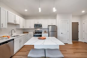 Capitol Heights apartment for rent - a white kitchen with stainless steel appliances and a white counter top