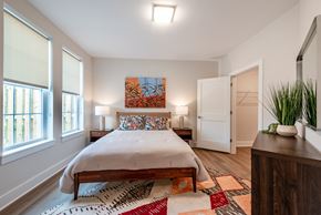 Capitol Heights apartment for rent - a bedroom with a bed and a dresser and two windows