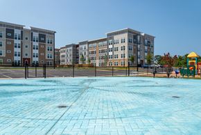 Capitol Heights apartment for rent - an empty playground with an apartment building in the background