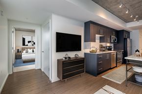 Seattle apartment for rent - A modern kitchen with dark wood cabinets and a white countertop.