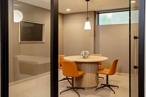 San Diego apartment for rent - A modern dining room with a round table and orange chairs.