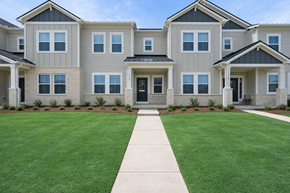 Charlotte townhouse for rent - A row of houses with a green lawn in front.