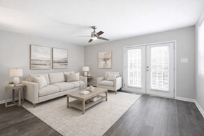 Chapel Hill apartment for rent - A living room with a white couch, a coffee table, and a ceiling fan.