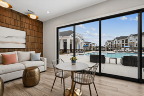 Columbia apartment for rent - A modern living room with a view of a pool and houses outside.