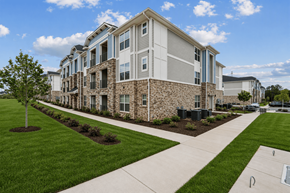 Columbia apartment for rent - A modern apartment building with a well-maintained lawn in front.