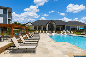 Charlotte apartment for rent - A pool area with sun loungers and a building in the background.