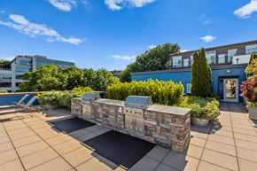 Seattle apartment for rent - a fire pit on the roof of a building with a blue sky in the background  at Dexter Lake Union, Seattle, WA
