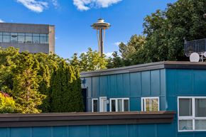 Seattle apartment for rent - a blue building with a view of the space needle in the background  at Dexter Lake Union, Seattle, Washington