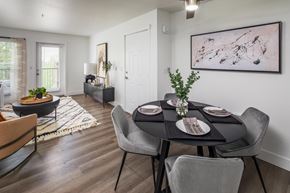Tigard apartment for rent - A dining room with a table set for two and a painting on the wall.