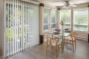 Beaverton apartment for rent - a dining room with white blinds and a table and chairs