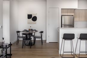 Vancouver apartment for rent - A modern dining area with a black table and chairs at The Arvon, Vancouver, WA
