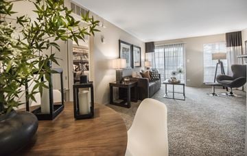 Lombard apartment for rent - A modern living room with a wooden table and white chairs.
