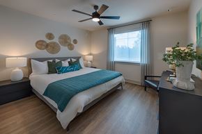 Huntsville apartment for rent - A bedroom with a large bed and a ceiling fan.