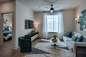Huntsville apartment for rent - A living room with a green chair and a white couch.