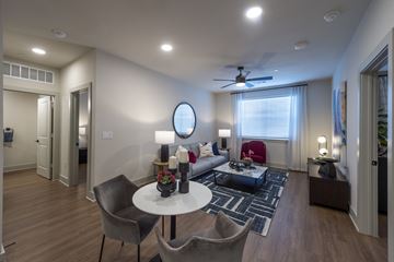 Benbrook apartment for rent - A modern living room with a white table and grey chairs.