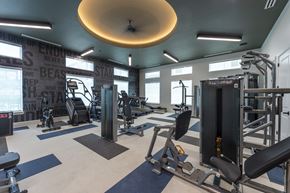 Huntsville apartment for rent - A gym with a variety of equipment including weights and cardio machines.