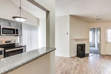 Virginia Beach apartment for rent - A kitchen with a granite countertop and a stove top oven.