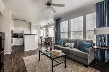 Lakewood apartment for rent - A living room with a grey couch and a glass coffee table.