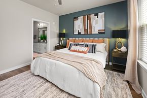 Charlotte apartment for rent - A bedroom with a large bed and a painting on the wall.