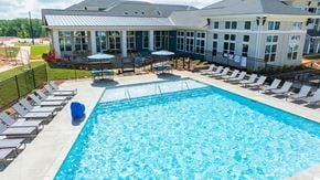 Mooresville apartment for rent - a large swimming pool with a house in the background