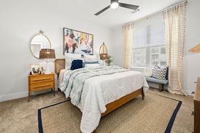 Mooresville apartment for rent - a bedroom with a bed and a ceiling fan