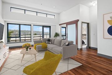 Seattle apartment for rent - A living room with a yellow chair and a grey couch.