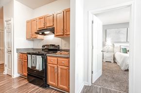 Stockbridge apartment for rent - A kitchen with wooden cabinets and a black oven.