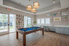 Wildwood triplex for rent - a game room with a pool table and a window