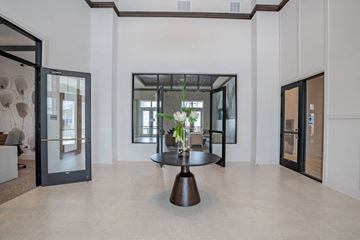 West Melbourne apartment for rent - a living room with a table and glass doors