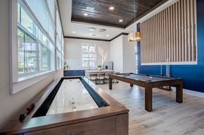 West Melbourne apartment for rent - a game room with a shuffleboard table and a pool table