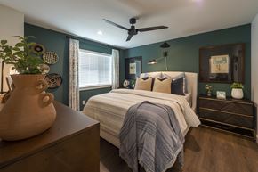 Katy apartment for rent - a bedroom with a bed and a ceiling fan