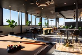 Denver apartment for rent - a lounge area with a pool table and tables and chairs