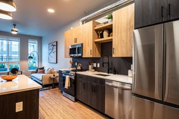 Modern stainless-steel appliances, custom cabinets, and quartz countertops