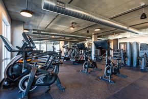 Denver apartment for rent - a gym with various exercise bikes and weights