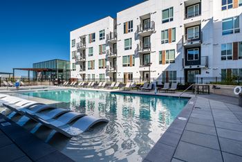 Modern rooftop pool, fire pits, and spa with cabanas