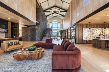 Flagstaff apartment for rent - A living room with a red couch and a wooden coffee table.