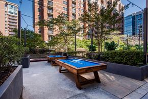 Alexandria apartment for rent - A pool table in a courtyard surrounded by buildings.