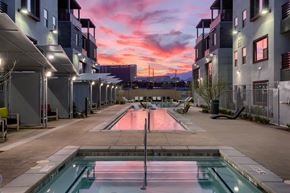 Las Vegas apartment for rent - a sunset over an apartment complex with a pool in the foreground