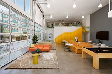 Nashville apartment for rent - A brightly colored living room with a pool table and a balcony.
