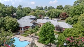 Memphis apartment for rent - A large house with a pool surrounded by trees.