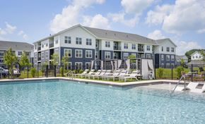 Londonderry apartment for rent - A large building with a pool in front.