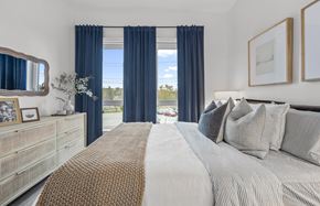Salem apartment for rent - A bedroom with a large bed and a dresser with a mirror.